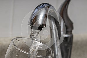 Glass at water tap and filling water with lead contamination