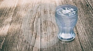 A glass of water on wood background