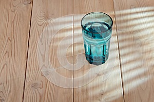 Glass with water on a wooden background. They are transparent and clear, they can contain water and someday have a reflection.