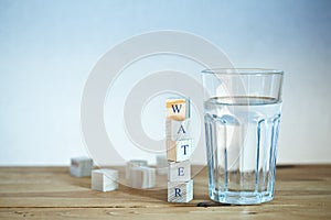 Glass of water with wooden blocks