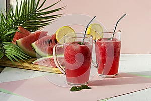 A glass of watermelon smoothie with ice, mint and lemon. Selective focus