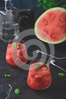 Glass of watermelon and strawberry cocktail with mint garnish
