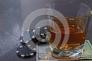 A glass of whiskey on a bank note, a poker game.