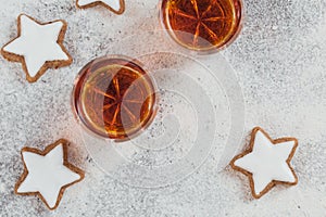A glass of whiskey or bourbon, star cookies and decoration on white background
