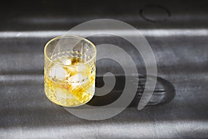 Glass of whiskey on dark background. Close up photo