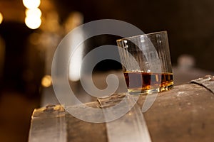Glass of whiskey in distillery photo