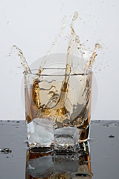 Bourbon or Scotch. Advertising glasses in a freeze frame with ice