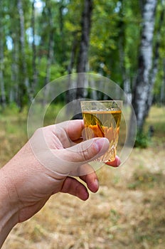 glass of whiskey in hand