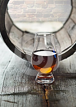 Glass of whiskey and a old barrel