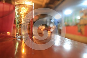 A glass of whiskey on the table.