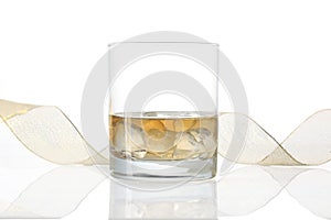 Glass of whiskey with a yellow ribbon isolated ano white background with copy space for your text