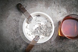 Glass of whisky, ashtray and cigars on the table