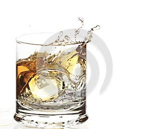 A Glass of whisky with ice cube splash