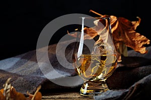 Glass with Whisky and Scottish Plaid Scarf