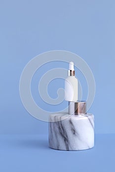 Glass white bottle cosmetic serum cerulean background