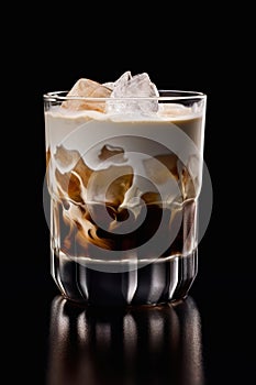 Glass of White Russian cocktail on black background.