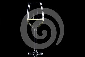 Glass of white wine on black