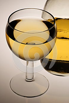 Glass of white wine and bottle