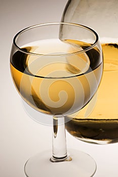 Glass of white wine and bottle