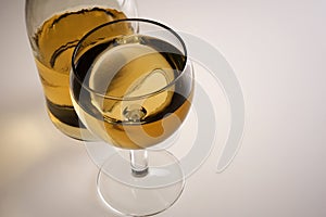 Glass of white wine and bottle