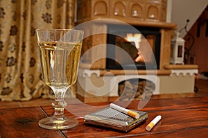 Glass of white wine, cigarettes and snuffbox