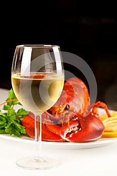 Glass of white wine with cooked lobster