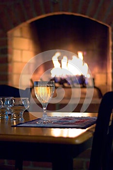 Glass of white wine in front of hearth