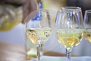 Glass with white wine poured on a cup photo