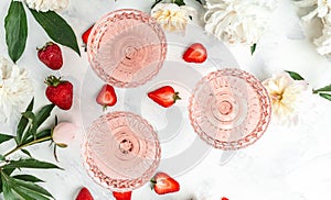 Glass Of White Wine, sweet fresh strawberries and Peony Flowers. Summer drink for party, wine shop or wine tasting concept