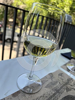 Glass of white wine on a table in a restaurant, close-up