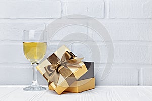 Glass with white wine for tasting and gift box for romantic surprise