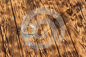 Glass of white wine on vintage wooden table