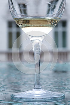 Glass of white wine on a watery surface