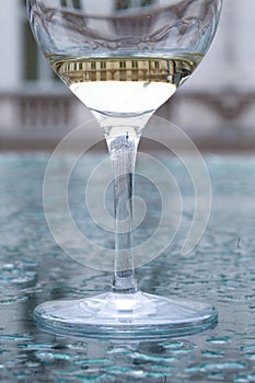 Glass of white wine on a watery surface