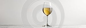 Glass of white wine on a white background with copy space