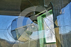 Glass window broken with a bullet hole