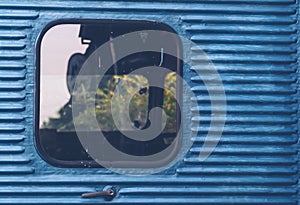 Glass window of old vintage train with blue container abstract travel background