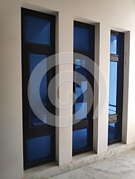 The glass window of room with black wood framework.