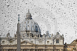 Glass window wih raindrops as it looks saint peter cathedral in