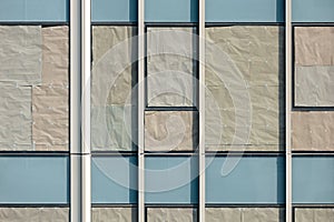 glass windows of condominium with crumple paper attachment