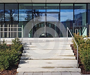 Glass windows ,  doors and staircase of a closed  modern   office  building