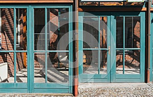 Glass windows and doors with turquoise frames