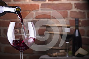 Glass of wine against a brick wall