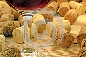 Glass of wine on background corks