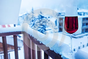 Glass of wine on balcony balustrade in hotel suite