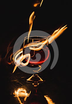 A glass of wine on a black background. Party club entertainment.