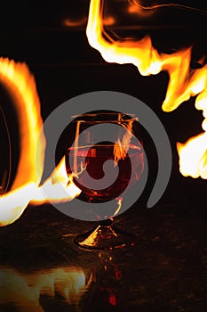 A glass of wine on a black background. Party club entertainment.