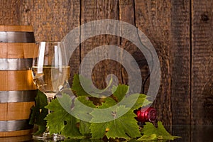 Glass of wine with bottle in grapeleaves