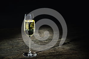 a glass of wine or champagne on a vintage wooden table background