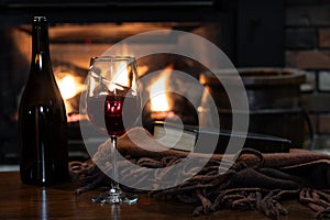 Glass of wine with fireplace in background